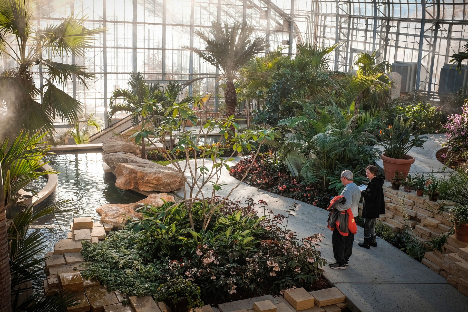 A couple walking through the indoor gardens at Lauritzen Gardens